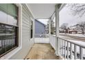 Covered front porch with white railings, offering a view of the neighborhood at 6938 Bluffgrove Cir, Indianapolis, IN 46278