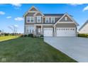 Two-story house with gray siding, three-car garage, and landscaped lawn at 4225 Edelweiss Dr, Plainfield, IN 46168