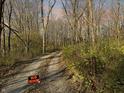 Gravel driveway leading into a wooded area with a no trespassing sign at 720 E 400 N, Anderson, IN 46012