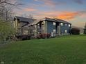 Back exterior of home showcasing stone and wood details with deck at 720 E 400 N, Anderson, IN 46012