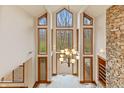 Two story living room with stone fireplace and large windows at 720 E 400 N, Anderson, IN 46012