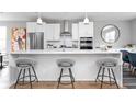 Modern kitchen with white cabinets, quartz island, and hardwood floors at 1224 Alabama St, Indianapolis, IN 46202