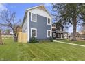 Gray siding, white trim, two-story home with a side yard at 1519 N Beville Ave, Indianapolis, IN 46201