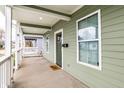 Inviting front porch with white railings and a green door at 2312 E Woodlawn Ave, Indianapolis, IN 46203