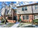 Brick front townhouse with green door, walkway, and landscaping at 9464 Maple Way # 27, Indianapolis, IN 46268