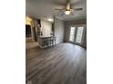 Open living room with hardwood floors and access to a balcony at 12938 University Cres # Apt 2B, Carmel, IN 46032