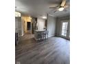Open living area with hardwood floors and kitchen island at 12938 University Cres # Apt 2B, Carmel, IN 46032