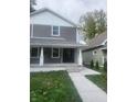Two-story gray house with white accents, a front porch, and walkway at 1826 N Dexter St, Indianapolis, IN 46202