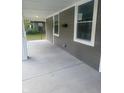 Spacious front porch with concrete flooring and white columns at 1826 N Dexter St, Indianapolis, IN 46202