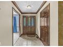 Spacious entry hall with wood doors and tile flooring at 2021 Edgewood Dr, Danville, IN 46122