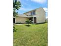Two-story yellow house with a small tree and lawn at 5236 Bluff View Dr, Indianapolis, IN 46217