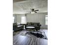 Spacious living room with gray sofas, coffee table, and hardwood floors at 5236 Bluff View Dr, Indianapolis, IN 46217