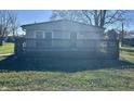 Single story home with a wooden deck and fenced yard at 8418 S State Road 39, Clayton, IN 46118