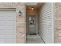 Inviting front entry with a brick facade and a charming wreath at 10655 Swan Ct, Indianapolis, IN 46231