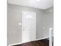 Front entry with white door, dark hardwood floor, and neutral walls at 1709 Queensbridge Dr, Indianapolis, IN 46219