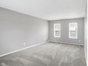 Spacious living room with neutral gray walls and gray carpeting at 1709 Queensbridge Dr, Indianapolis, IN 46219