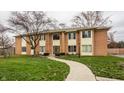 Front view of brick building with lawn and walkway at 589 E Hunters Dr # D, Carmel, IN 46032