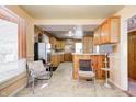 Kitchen with wood cabinets, tile backsplash, and tile floor at 80 S Mickley Ave, Indianapolis, IN 46241