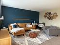 Modern living room with an L-shaped sectional sofa and accent chair at 10048 New Dawn Pl, Avon, IN 46123