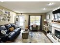 Cozy living room featuring a fireplace and comfortable seating at 10048 New Dawn Pl, Avon, IN 46123