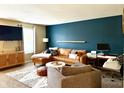 Modern living room with an L-shaped sectional sofa and accent chair at 10048 New Dawn Pl, Avon, IN 46123