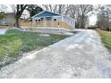 Newly built home with gray siding, a deck, and a gravel driveway at 11365 W State Road 142, Martinsville, IN 46151
