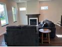 Living room with a cozy fireplace and dark hardwood floors at 1210 Churchman Ave, Indianapolis, IN 46203