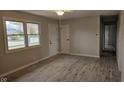 Spacious living room with neutral walls, wood-look floors, and a ceiling fan at 46 Crestview Dr, Greenwood, IN 46143