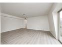 Spacious living room featuring light gray wood-look floors and a door at 305 Elmead Ct # 3012, Greenwood, IN 46142