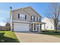 Two-story house with a neutral color scheme and stone accents at 3796 Indigo Blue Blvd, Whitestown, IN 46075