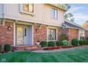 Attractive entryway with brick facade, landscaping, and a glass front door at 4677 Bedford Ct, Carmel, IN 46033