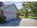 Two-car attached garage with a basketball hoop in the background at 4677 Bedford Ct, Carmel, IN 46033