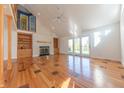 Bright living room with hardwood floors, a fireplace, and access to a backyard patio at 4770 Winterberry Pl, Columbus, IN 47201
