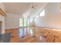 Sunlit living room showcasing hardwood floors, a fireplace, and access to a backyard patio at 4770 Winterberry Pl, Columbus, IN 47201