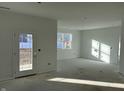 Bright living room with large windows and patio door at 5226 Woodhurst Ln, Indianapolis, IN 46239