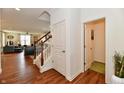 Hardwood floors, coat closet, and view of living room at 6625 Harvest Moon Ln, Whitestown, IN 46075