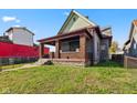 Brick house with a covered porch, needing some repairs at 14 N Tacoma Ave, Indianapolis, IN 46201