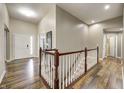 Hardwood floor hallway with staircase and neutral colors at 1945 Saratoga Dr, Greenwood, IN 46143