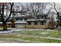 Two-story brick home with attached garage and landscaped lawn at 927 Stockton St, Indianapolis, IN 46260