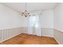 Simple dining room featuring hardwood floors and a chandelier at 9617 Lincoln Blvd, Carmel, IN 46280