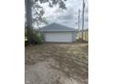 Detached two-car garage with white doors at 1613 Section St, Plainfield, IN 46168