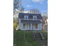 Two-story house needing renovation, with brown roof and small lawn at 2702 Boulevard Pl, Indianapolis, IN 46208