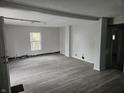 Large living room with gray vinyl flooring and a window at 2702 Boulevard Pl, Indianapolis, IN 46208