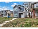 Two-story navy blue house with white trim, steps leading to the front door, and autumn leaves on the lawn at 416 Eastern Ave, Indianapolis, IN 46201