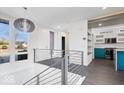 Open concept entryway with modern staircase and a view of the kitchen at 7650 Clarion Dr, Indianapolis, IN 46236