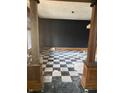 Living room with a checkerboard floor and wooden pillars at 1146 W Congress Ave, Indianapolis, IN 46208