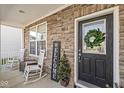 Front porch with rocking chairs, a welcome sign, and a wreath at 3466 Limelight, Whitestown, IN 46075