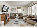 Cozy living room featuring brown couches and a fireplace at 6017 N Oakland Ave, Indianapolis, IN 46220