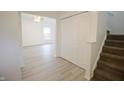 Bright entryway with a staircase, coat closet and view of the living room at 7144 Kimble Dr, Indianapolis, IN 46217