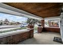 Brick front porch with wooden ceiling and street view at 722 S Sherman Dr, Indianapolis, IN 46203